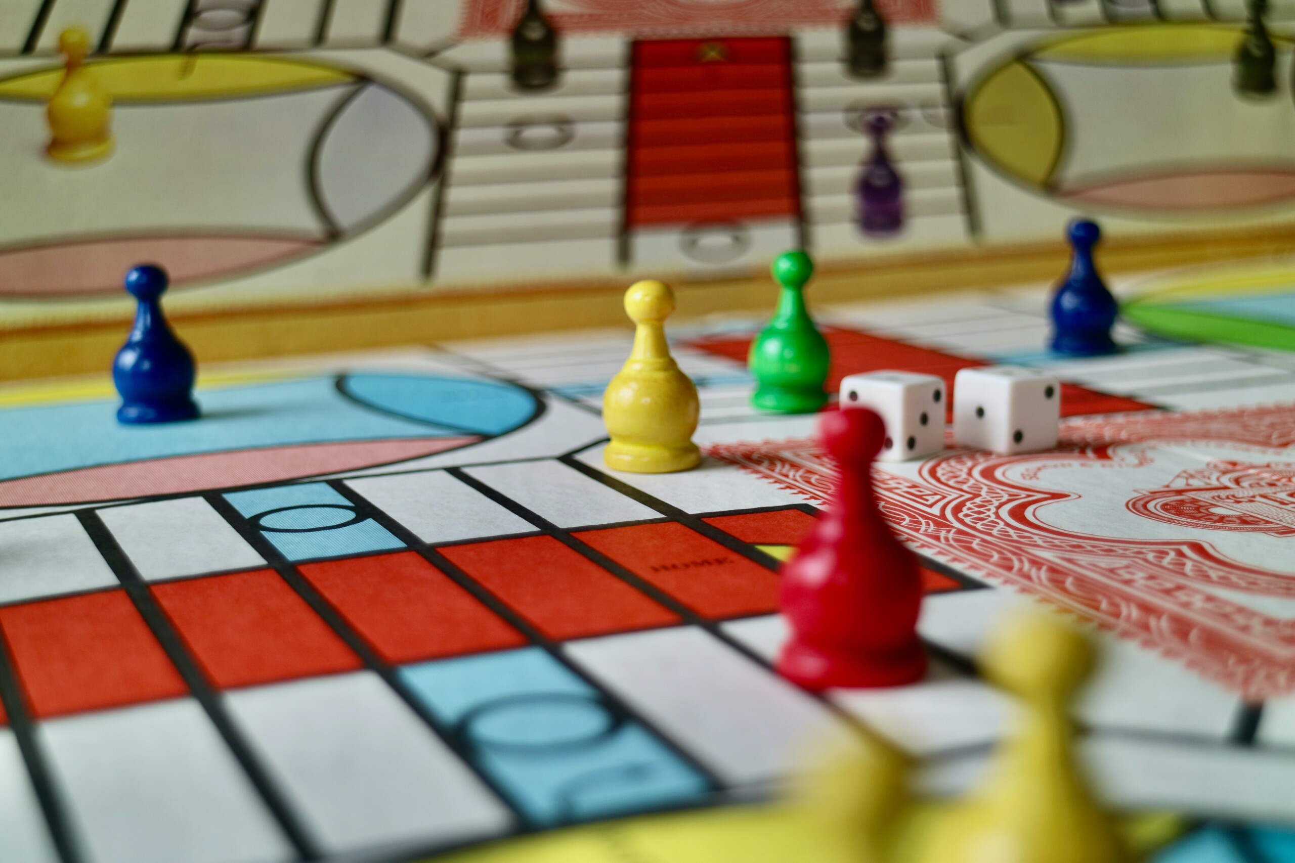 Friends Having Fun Playing Ludo Board Game while Spending Leisure